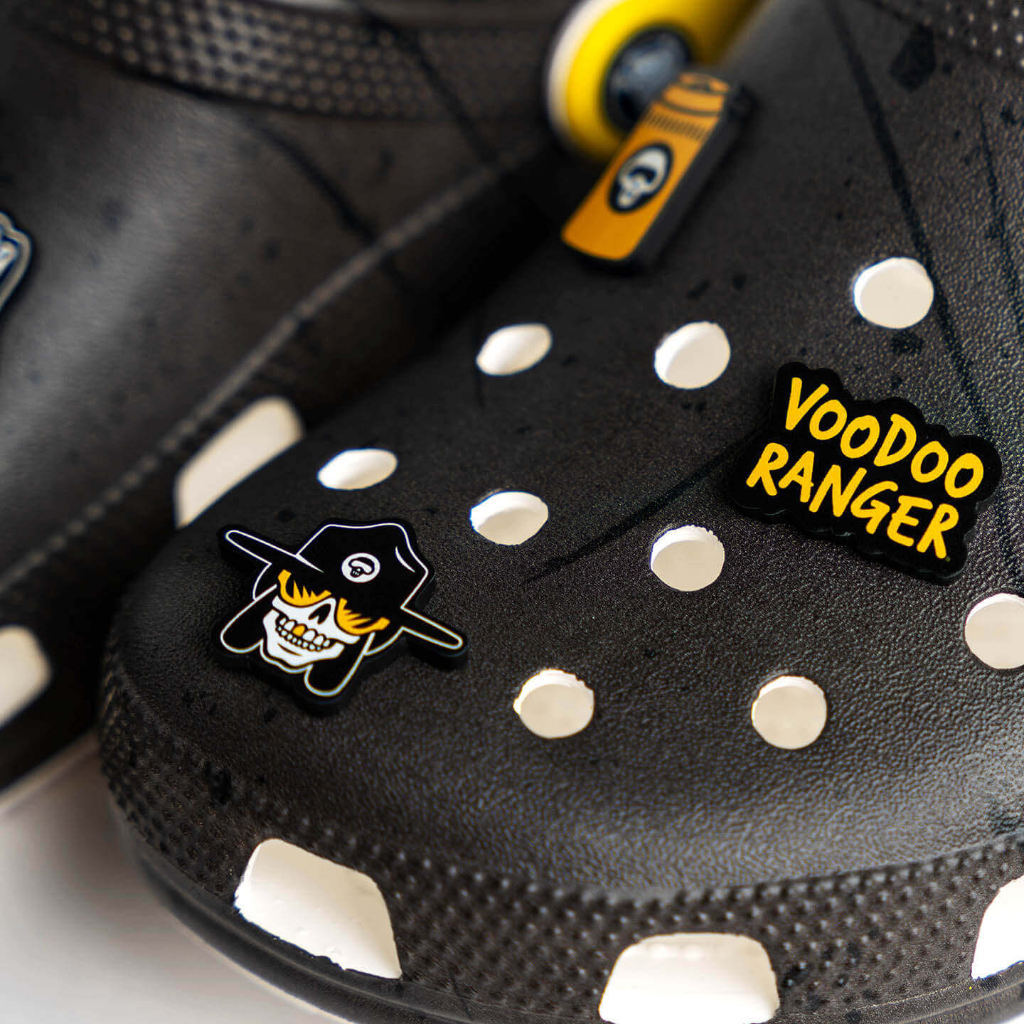 Three of the Voodoo Ranger jibbitz shown on one black Croc