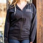 Woman wearing zip hoodie. It's a relaxed fit with the white outlined Voodoo Ranger logo laser printed on the front upper left side. 